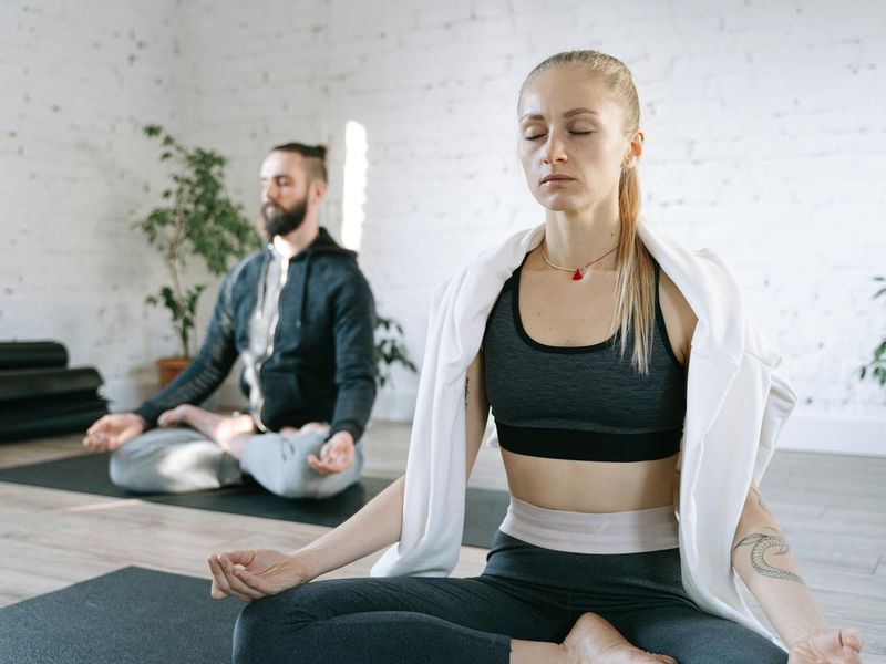 Serene woman in a seated yoga position focusing on breath.