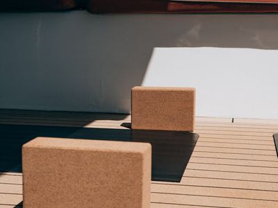 Soft light hitting a wooden floor with yoga equipment.